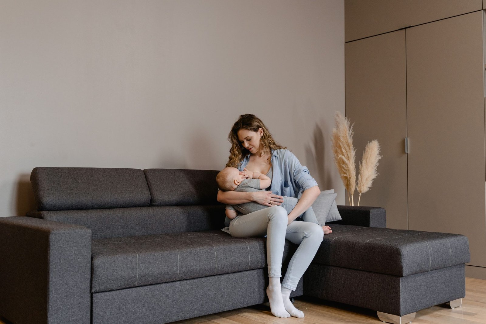 Mum nursing baby comfortably at home